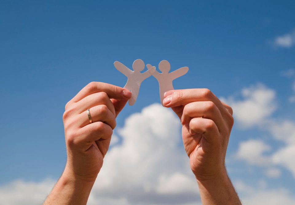 paper dolls against sky