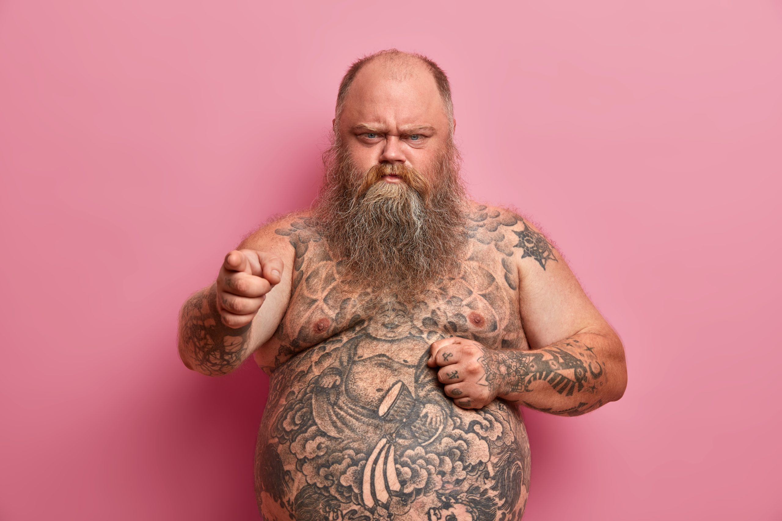 angry offended overweight man keeps hand big naked tummy blames you hears offensive words about himself has tattooed body long thick beard made keep diet scaled